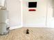 Garage with water heater and pegboard storage at 2071 Sifield Greens Way # 103, Sun City Center, FL 33573