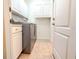 Laundry room with washer, dryer and cabinets at 2071 Sifield Greens Way # 103, Sun City Center, FL 33573