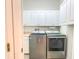 Laundry room with washer, dryer and cabinets at 2071 Sifield Greens Way # 103, Sun City Center, FL 33573