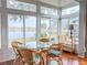 Sunroom boasts a lake view and glass windows at 2071 Sifield Greens Way # 103, Sun City Center, FL 33573
