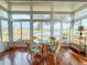 Sunroom with lake view, wicker furniture, and hardwood floors at 2071 Sifield Greens Way # 103, Sun City Center, FL 33573