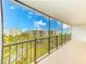 Spacious balcony overlooking lush greenery with views of the building and water at 220 Belleview Blvd # 811, Belleair, FL 33756
