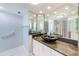 Modern bathroom featuring ample lighting, granite countertop, and ample mirror space at 220 Belleview Blvd # 811, Belleair, FL 33756