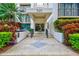 Building entrance with landscaping and paved walkway at 220 Belleview Blvd # 811, Belleair, FL 33756