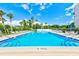 Inviting community pool with lounge chairs and patio tables at 220 Belleview Blvd # 811, Belleair, FL 33756