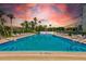 Inviting community pool with lounge chairs and patio tables at 220 Belleview Blvd # 811, Belleair, FL 33756