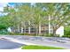 Building exterior with lush landscaping and tree-lined street at 220 Belleview Blvd # 811, Belleair, FL 33756
