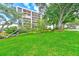 Building exterior showcasing lush landscaping and a parking area at 220 Belleview Blvd # 811, Belleair, FL 33756