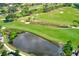 Aerial view of a lush green golf course with pond and trees at 220 Belleview Blvd # 811, Belleair, FL 33756