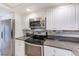 Well-equipped kitchen featuring stainless steel appliances, ample counter space, and white cabinetry at 220 Belleview Blvd # 811, Belleair, FL 33756