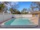 Back yard featuring an in-ground pool surrounded by a privacy fence and mature trees at 2803 W Lake Ave, Tampa, FL 33607