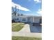 White single story house with carport and landscaped lawn at 2910 W Burke St, Tampa, FL 33614