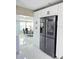 Modern kitchen with stainless steel refrigerator and white cabinets at 2910 W Burke St, Tampa, FL 33614