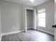 Bedroom with a closet, gray walls and wood-look flooring at 29120 Rivergate Run, Wesley Chapel, FL 33543