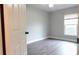 Neutral bedroom with wood-look floors and large window at 29120 Rivergate Run, Wesley Chapel, FL 33543