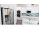 Modern kitchen with stainless steel appliances and white cabinets at 29120 Rivergate Run, Wesley Chapel, FL 33543