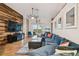 Bright living room featuring wood accent wall and cozy blue sectional at 30618 Tremont Dr, Wesley Chapel, FL 33543