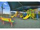 Brightly colored playground under a shade structure with bench seating at 30618 Tremont Dr, Wesley Chapel, FL 33543