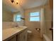 Clean bathroom with tub and updated vanity at 3090 Arrowhead Rd, Venice, FL 34293