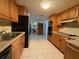Bright kitchen, with wood cabinets and view to dining area at 3090 Arrowhead Rd, Venice, FL 34293