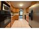Galley-style kitchen with wood cabinets and appliances at 3090 Arrowhead Rd, Venice, FL 34293