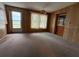 Spacious living room with large window and wood paneling at 3090 Arrowhead Rd, Venice, FL 34293