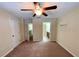 Spacious bedroom with ceiling fan and access to bathroom at 31247 Claridge Pl, Wesley Chapel, FL 33543