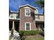 Two-story townhome with stone facade and lush landscaping at 31247 Claridge Pl, Wesley Chapel, FL 33543