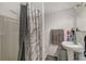 Clean bathroom with shower stall, pedestal sink, and storage at 3147 Prescott N St, St Petersburg, FL 33713