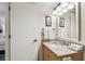 Bathroom with a granite top vanity, mirror, and sink at 36750 Us Highway 19 # 24209, Palm Harbor, FL 34684