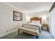 Comfortable bedroom with a well-made bed, bench, and stylish side tables at 36750 Us Highway 19 # 24209, Palm Harbor, FL 34684