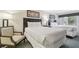 Hotel bedroom with two beds, a sitting chair, lamps, and wall art at 36750 Us Highway 19 # 24209, Palm Harbor, FL 34684
