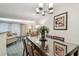 Elegant dining room features a stylish chandelier and a large, reflective table at 36750 Us Highway 19 # 24209, Palm Harbor, FL 34684