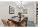 Cozy dining room featuring a modern chandelier, artwork, and stylish seating at 36750 Us Highway 19 # 24209, Palm Harbor, FL 34684