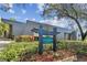 Attractive building exterior with sign and landscaping on a sunny day at 36750 Us Highway 19 # 24209, Palm Harbor, FL 34684