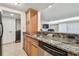 Kitchen features granite countertops and stainless steel dishwasher at 36750 Us Highway 19 # 24209, Palm Harbor, FL 34684