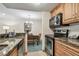 Kitchen with stainless steel appliances, and granite countertops, next to dining area at 36750 Us Highway 19 # 24209, Palm Harbor, FL 34684