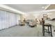 Spacious living room featuring comfortable seating, natural light, and a view into the dining area at 36750 Us Highway 19 # 24209, Palm Harbor, FL 34684