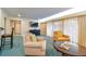 Bright living room with comfortable seating, television, and sheer curtains at 36750 Us Highway 19 # 24209, Palm Harbor, FL 34684