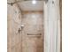 Walk-in shower with tile surround, grab bar, shower head and handheld sprayer at 36750 Us Highway 19 # 24209, Palm Harbor, FL 34684