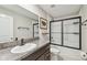 Bathroom with dark brown vanity, granite countertop and a tub shower at 4654 Wild Senna Blvd, Tampa, FL 33619