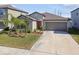 One-story home with gray siding, brown roof, and a two-car garage at 4654 Wild Senna Blvd, Tampa, FL 33619