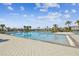 Relaxing community pool with lounge chairs and palm trees at 4654 Wild Senna Blvd, Tampa, FL 33619