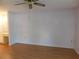 Simple bedroom with ceiling fan and hardwood floors at 4708 Lacrosse Ct, New Port Richey, FL 34655