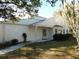 White single story home with mature landscaping and a spacious yard at 4708 Lacrosse Ct, New Port Richey, FL 34655