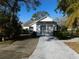 Front view of a single story home with a carport and landscaping at 4708 Lacrosse Ct, New Port Richey, FL 34655