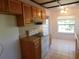 Kitchen with wood cabinets, tile floor and appliances at 4708 Lacrosse Ct, New Port Richey, FL 34655