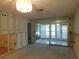 Renovation in progress, features a sliding glass door and chandelier at 4708 Lacrosse Ct, New Port Richey, FL 34655
