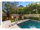 Inviting pool area with lush landscaping and patio seating at 4902 Carranza Ct, Tampa, FL 33616