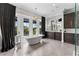 Spa-like bathroom featuring a freestanding tub and French doors leading to a balcony at 4902 Carranza Ct, Tampa, FL 33616